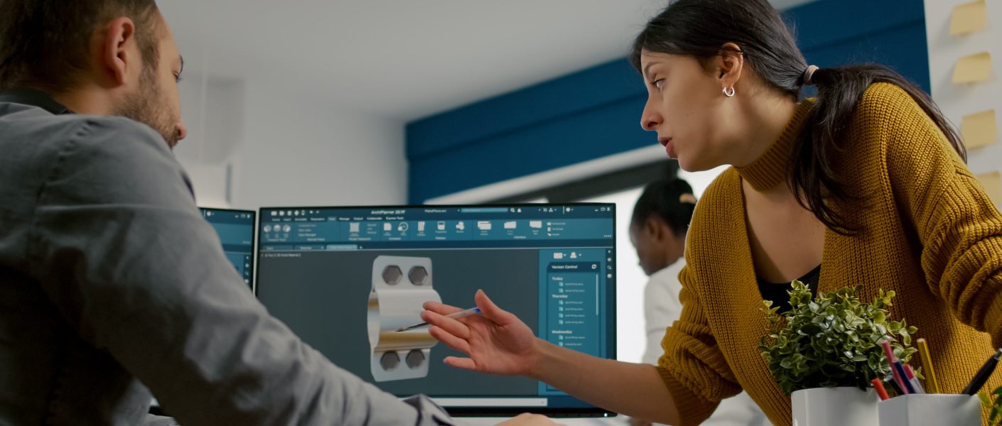 Inżynierowie omawiają projekt elementu konstrukcyjnego na ekranie komputera, modelowanie 3d w budownictwie w programie CAD