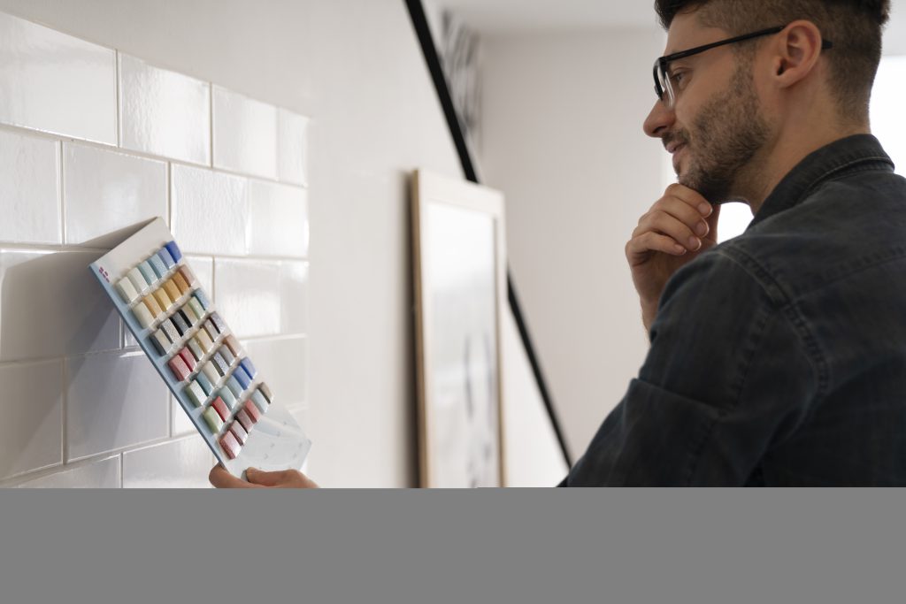 mężczyzna wybierający kolor kafelek w łazience - projekty łazienek trójmiasto