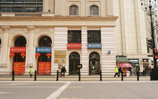 Na zdjęciu widać elegancki budynek o klasycznej, monumentalnej architekturze z kolumnami i zdobioną fasadą